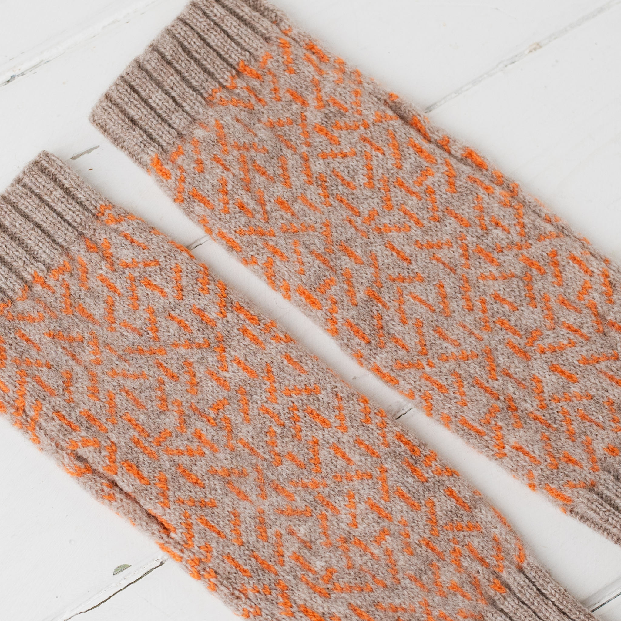 Scatter wrist warmers - cobble and orange soda