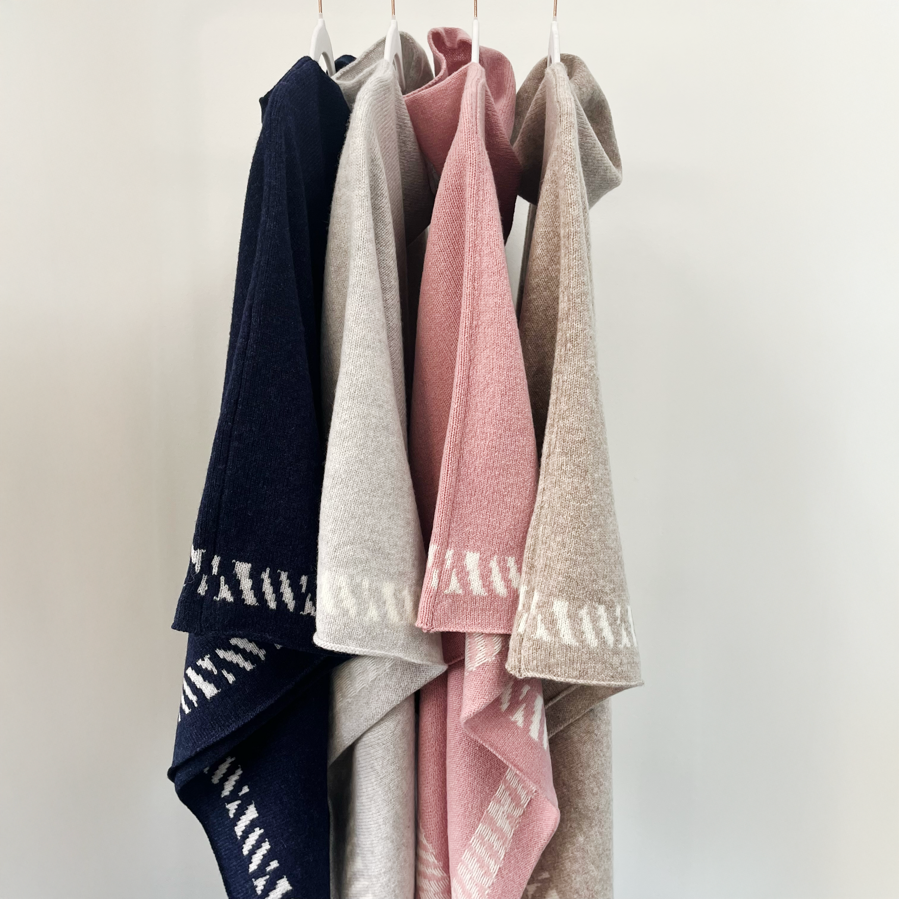 Lambswool knitted poncho - calamine pink and white